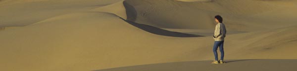Clarissa Augustinus standing sideways on a Namib sand dune