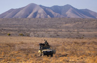 Paul Augustinus and Land Cruiser parked in the Rift Valley with Burko Mountain in the background