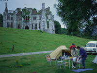 A campsite beneath a ruined English manor house in West Cork, Ireland