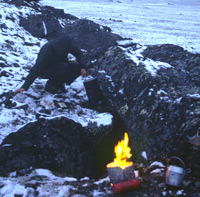 Clarissa Augustinus prepares a meal out in the open on an Alaskan ridge in denali National Park