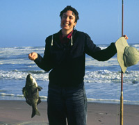 Clarissa Augustinus poses with her catch next to the Atlantic Ocean in the Skeleton Coast National Park in Namibia