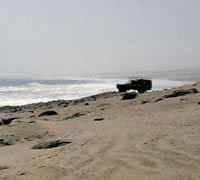 The vehicle of Paul and Clarissa Augustinus on the beach of the Skeleton Coast in Namibia