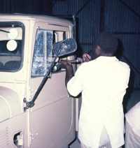 An official sprays Paul Augustinus Land Cruiser cab at Shorobe, Botswana