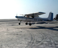 Lloyd Wilmot landing his plane on the salt next to Kubu Island in the Sua Pan in central Botswana