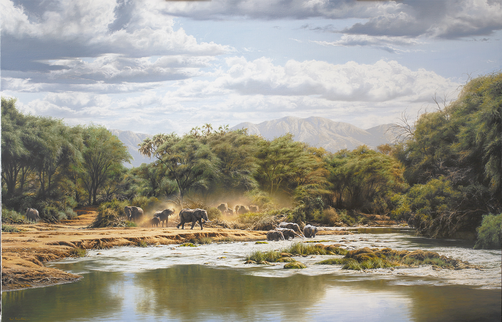A Paul Augustinus painting of a herd of elephant drinking from a wide palm-fringed river with mountain scenery in the background
